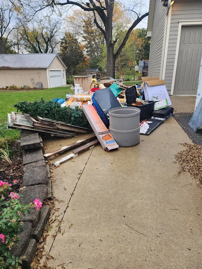 Dumpster being loaded with debris for 12 Yard Dumpster Rental in Connerton
